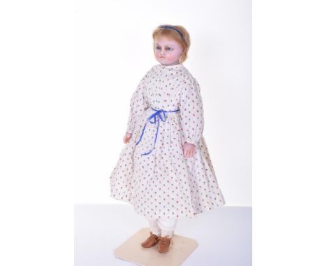 Poured wax shoulder head doll, English circa 1860, with blue glass eyes, inserted lashes, brows and light brown shoulder leng
