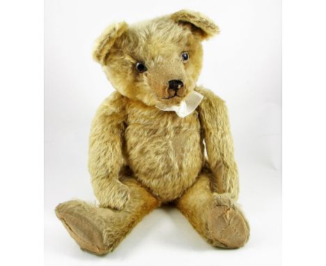 A charming English Teddy bear, 1930’s  the light brown mohair bear with large glass eyes, black stitched nose and mouth, swiv