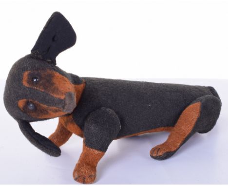 Steiff Dachshund toy dog, circa 1906, the black and tan straw filled burlap dog with black boot button eyes and stitched nose