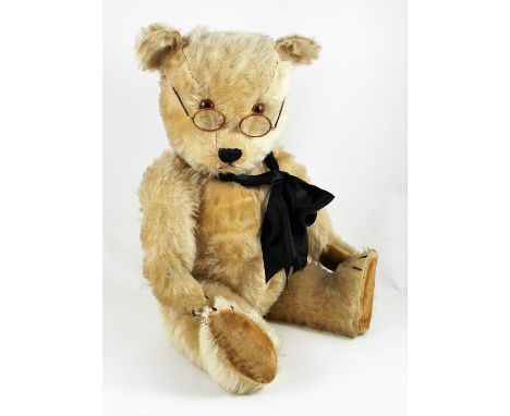A large Chiltern Hugmee Teddy bear, English 1950’s, the blonde mohair bear with orange glass eyes, black stitched nose, mouth
