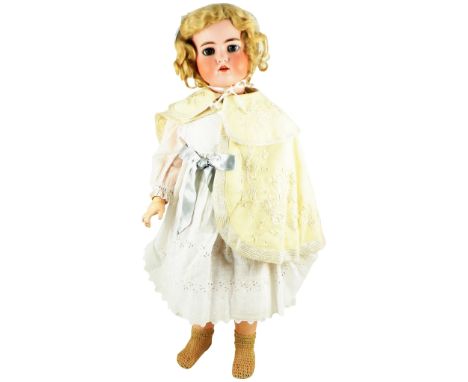 A Large Kammer & Reinhardt/S&H bisque head doll, circa 1910, with weighted blue glass eyes, open mouth, upper teeth and pierc