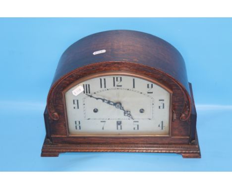 AN OAK MANTEL CLOCK
