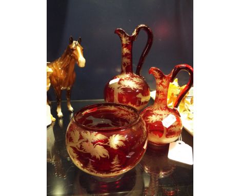 Two Bohemian ruby acid etched glass wine pourers and bowl having hunting scene decoration   Large jug 8" high has some deep g