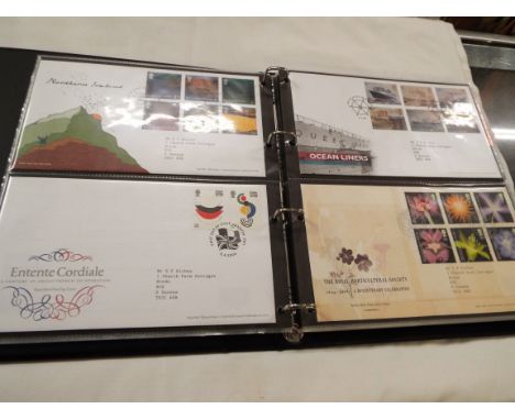 Three Stanley Gibbons albums containing a quantity of first day covers 