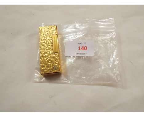 A Dunhill gold coloured lighter