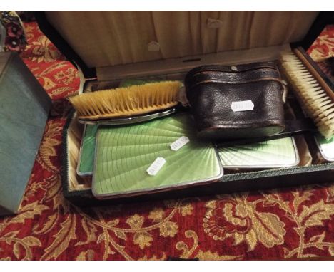 An art deco green enamel engine turned dressing table set comprising of mirrors and brushes together with a pair of early 20t