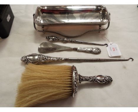 Two silver button hooks, brush and shoe horn together with a plated dish 