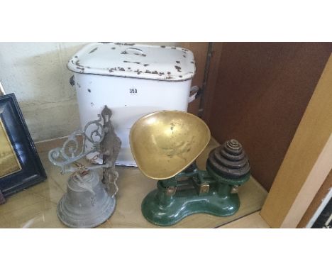An enamel bread bin together with a brass Angelus bell and a set of kitchen scales.
