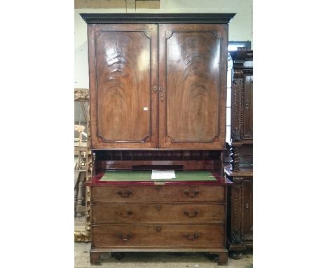 A late Georgian flame mahogany linen press secretaire with fitted cupboard, secretaire drawer and three drawers under, drop b