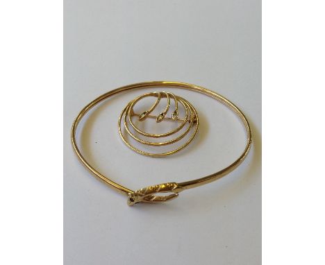 A 9 carat gold ladies' bangle with serpent's head to clasp together with a 9 carat gold and three stone diamond set brooch (9