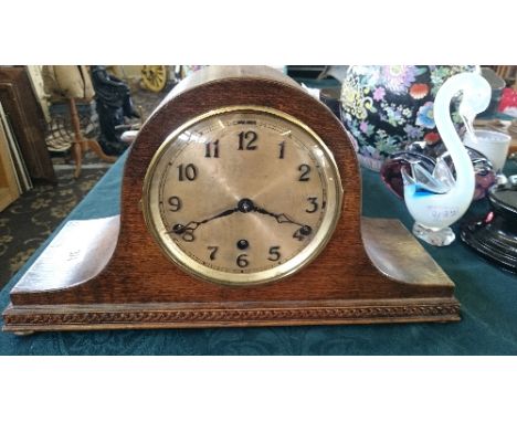 An early 20th century oak cased chiming mantle clock.