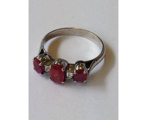 A white gold ruby and diamond set dress ring (2.8 grams overall).