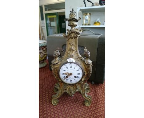 A 19th century Rococo style brass cased mantle clock with enamel dial, inscribed Enule Colvin & Cie.