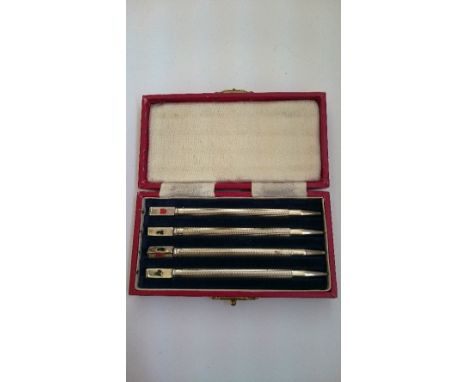 A set of four engine turned silver propelling pencils in original case.