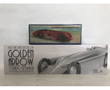 A Schylling Golden Arrow model and one other depicting the Sunbeam record car. 