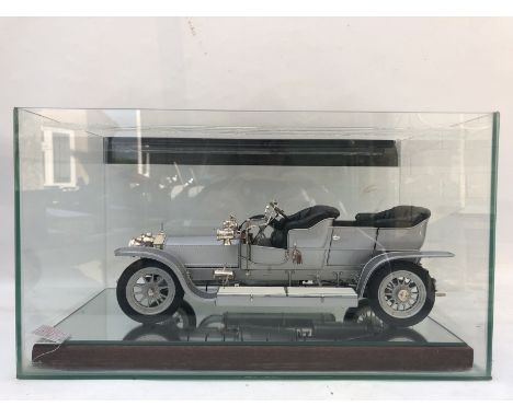 A good quality scale model of a Rolls-Royce Silver Ghost set within a glass case and another model made by Franklin Mint.