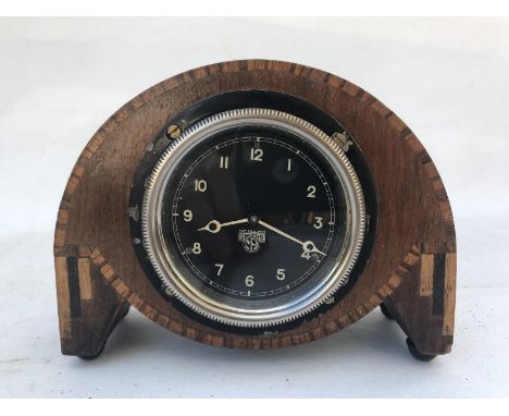 A Smiths black faced eight day car clock, rear wind, mounted for display, by repute overhauled and cleaned and in good workin