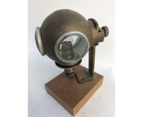 A Rotax diver's helmet tail lamp with lead-in fitting, display base mounted.