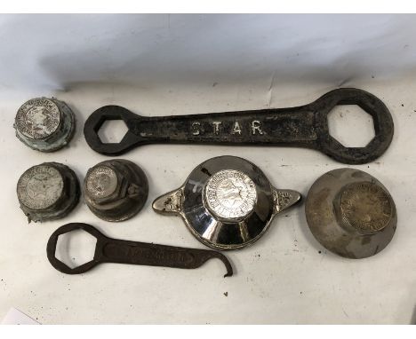 A large Star hubnut spanner, one smaller and five hubnuts for Star cars.