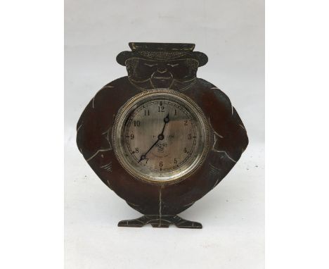 A Smiths silver faced eight day car clock, set within a brass mount, the mount shaped and engraved to depict John Bull. 