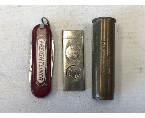 A Shell/BP promotional cigar cutter, a Freightliner penknife and a Goodyear gauge.
