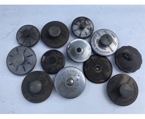 A small quantity of engine oil caps, mostly with advertising promoting the use of various grades of oil.