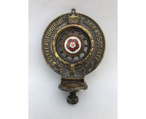 A Royal Automobile Club Associate car badge with Northamptonshire Automobile Club enamel centre, stamped N264.