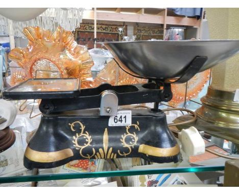 A set of kitchen scales with painted cast base.