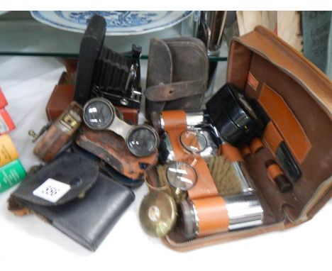 A mixed lot of leather cased shaving sets, binoculars, camera etc.,