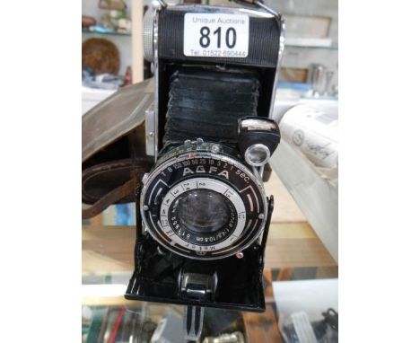 An Agfa folding camera in leather case.