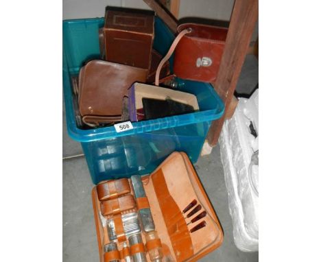 A crate containing a leather camera case and other boxes.