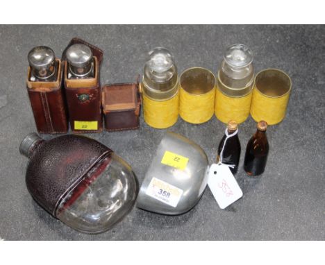 Hip flask, two miniature bottles of Guinness, four medicine bottles (two in leather sleeves, two in cardboard sleeves)