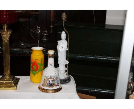 Bells Scotch Whiskey commemorative bell, figural table lamp and a Poole vase