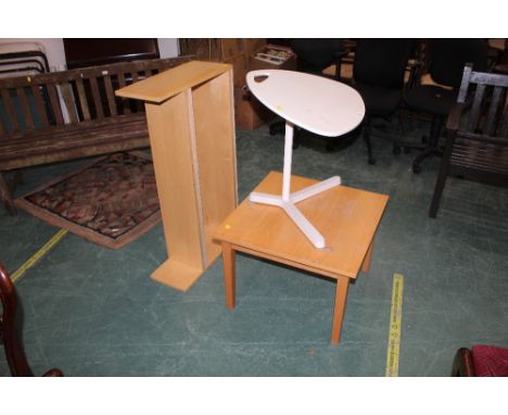 An IKEA white plastic adjustable table 60 cm high a light wood square occasional table an light wood book shelf 