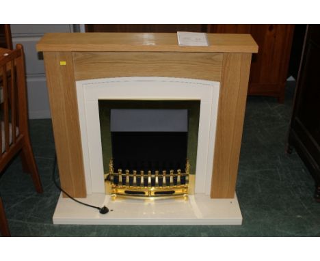 A  light oak and cream finish fire place suite containing electric fire, 93 cm high x 102 cm wide x 30 cm deep, sold with ins