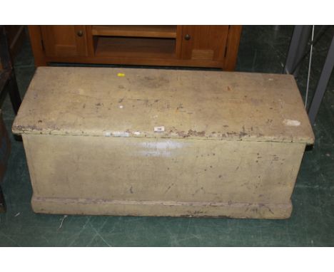 A 19th century pale yellow and orange painted pine two handled ships trunk with angled sides and with brown leather loop hand