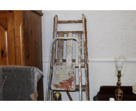 A vintage wooden step ladder and a metal step ladder 