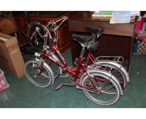 A vintage trekker folding bicycle and a vintage record folding bicycle 