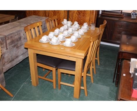 A modern light oak draw leaf dining table on square legs, 79 cm high x 220 cm extended x 9 cm wide, together with a set of fo