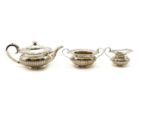 A three piece silver tea service,by James Dixon & Sons Ltd, Sheffield, 1923 and 1925, each cast with shell borders and reeded