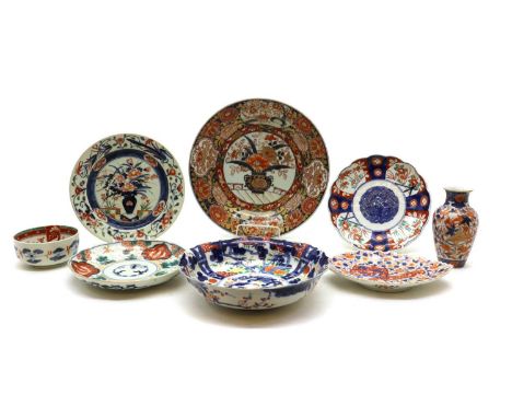 A collection of Japanese Imari ware,19th-20th century, comprising: a charger, a vase, a bowl, and five plates, all decorated 