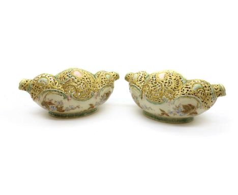 A pair of Zsolnay porcelain pierced baskets,19th century, of shell form, with a pale yellow and green ground, the interior pa