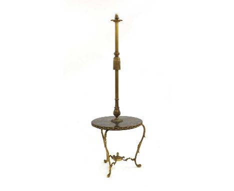 A standard lamp, with a brass column centred with a tasselled mount, over a marble shelf, the edge-mounted with pierced swags