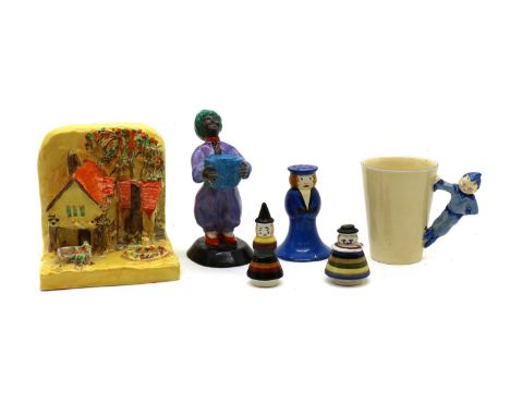 A collection of Clarice Cliff figural items,comprising; a sailor-shaped sugar shaker, a clown-shaped cuet set, a mug with a h