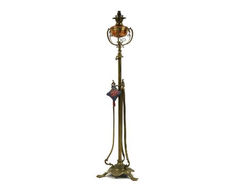 A Victorian floor standing brass and copper oil lamp,19th century, converted to electric, on paw feet140cm high to terminal C