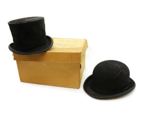 A silk top hat by Lock &amp; Co.,with a black ribboninternal measurements 6.5 inches wide, 5.5 inches deeptogether with a bow