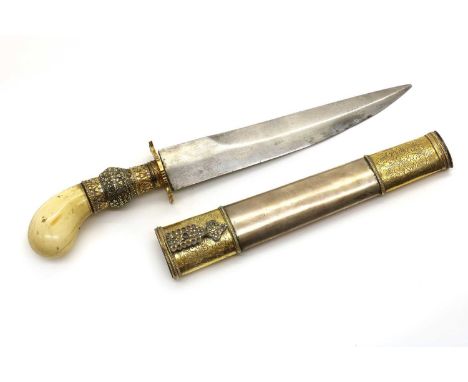 A Philippines Dagger or Punyal Kris,19th century, 10in blade, marine ivory pommel hilt and filigree decorated gold coloured m