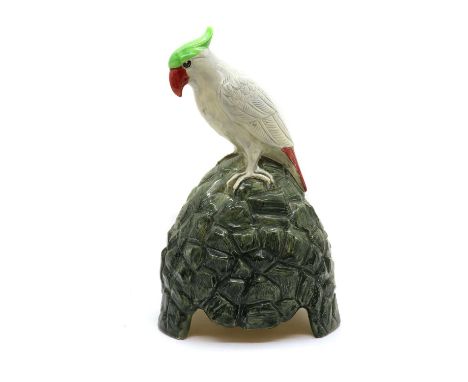 A Royal Doulton parrot speaker cover,c.1927, designed by Charles Noke, manufactured for Artandia Ltd., modelled as a cockatoo