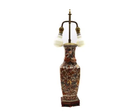 A porcelain table lamp,20th century, of tapering form, flanked by twin handles modelled as fruit, with Imari style decoration