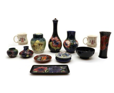 A collection of Moorcroft pottery pieces20th century, each piece tubeline-decorated, to include a table lamp, ginger jar, vas